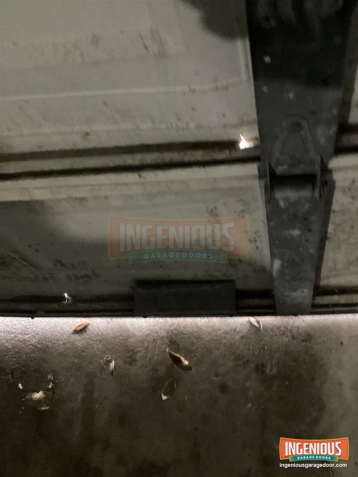 From inside, daylight shows through the cracked seam at the bottom of the door.