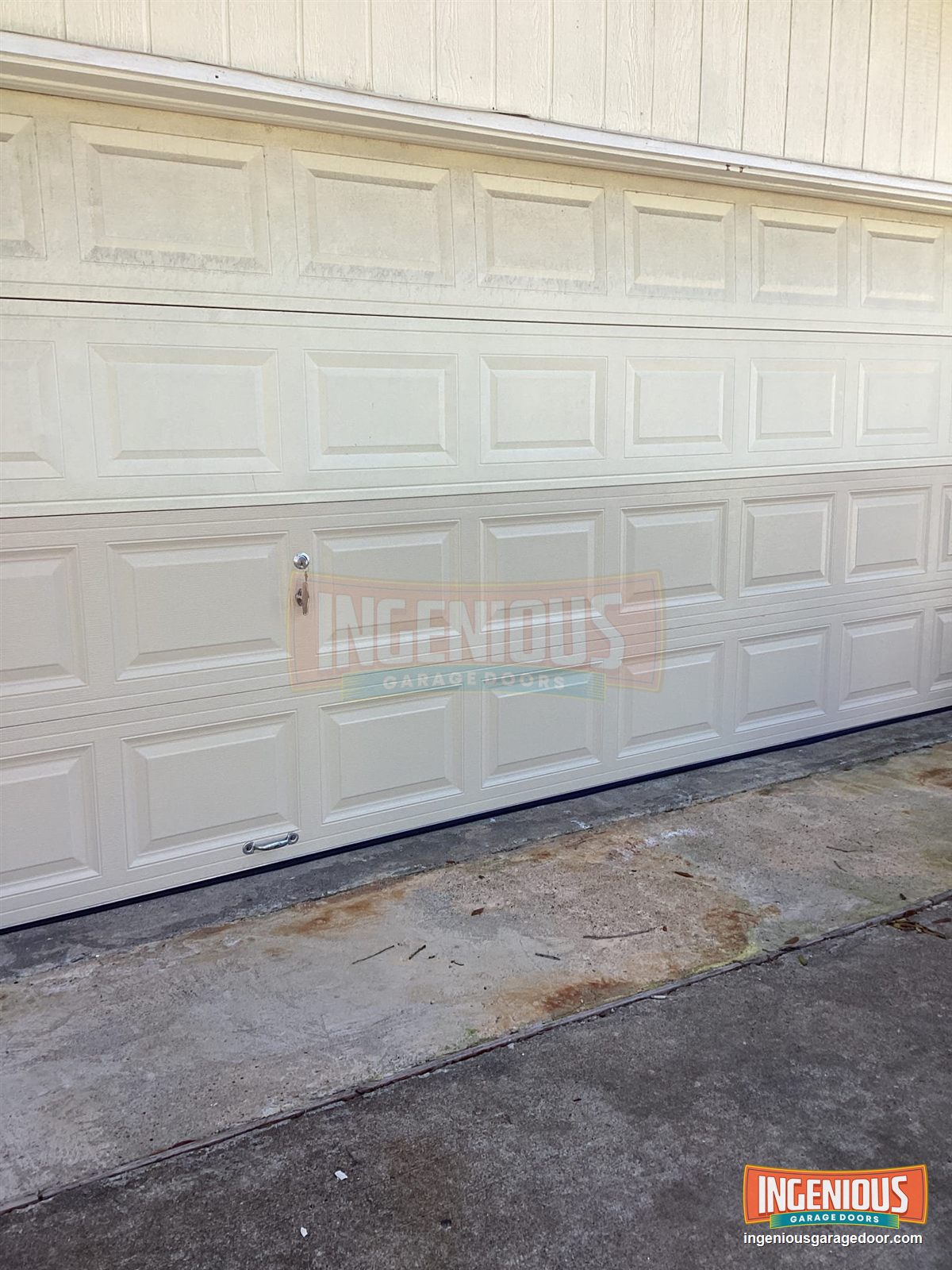 The repaired door from the driveway, closed and straight.